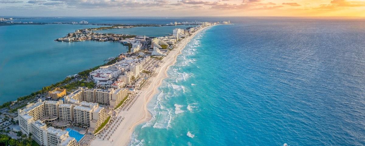 An aerial shot of Cancun's coastline at sunset