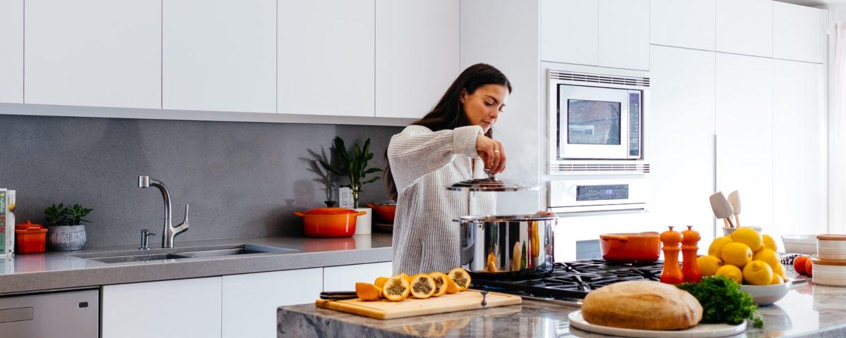 Woman cooking in self catering apartment 